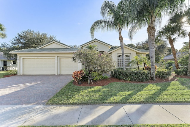 view of front of property with a garage and a front yard