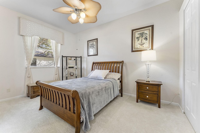 bedroom featuring ceiling fan and light carpet