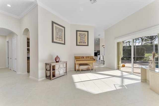 living area with light tile patterned floors and ornamental molding