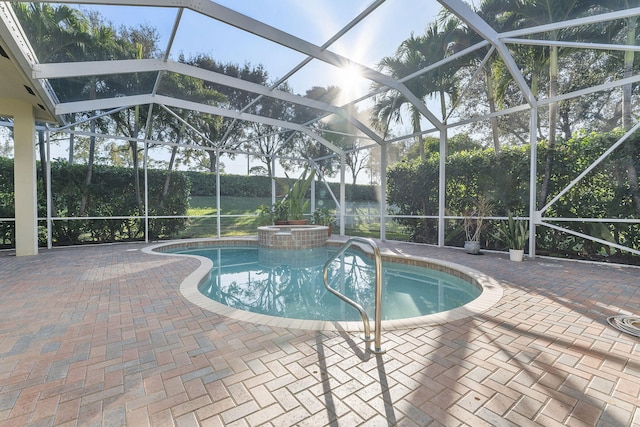 view of pool featuring a patio and glass enclosure