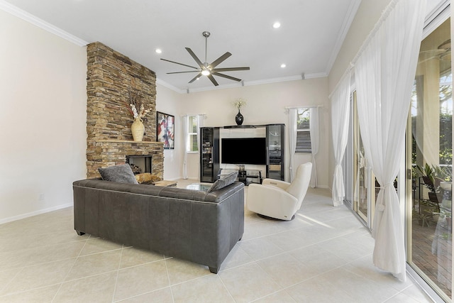 tiled living room with ornamental molding, a fireplace, and ceiling fan