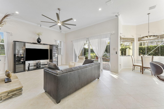 tiled living room featuring crown molding and ceiling fan