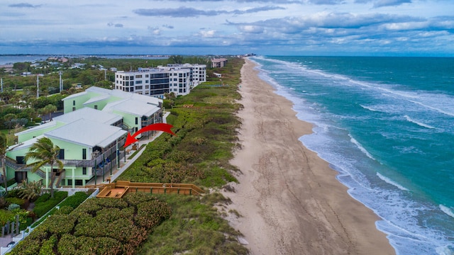 aerial view with a water view and a view of the beach