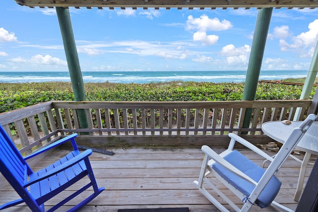 deck featuring a beach view and a water view