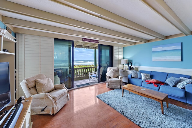 living room featuring beam ceiling and wood-type flooring