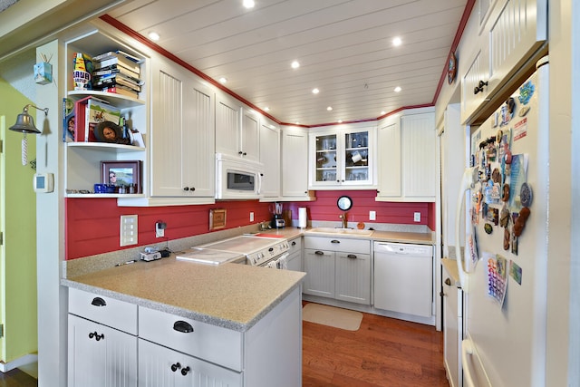 kitchen with white appliances, sink, hardwood / wood-style flooring, white cabinetry, and wood ceiling