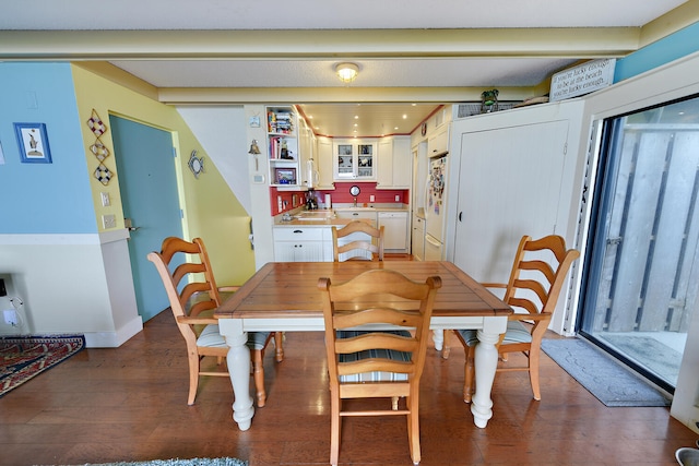 dining space with dark hardwood / wood-style floors