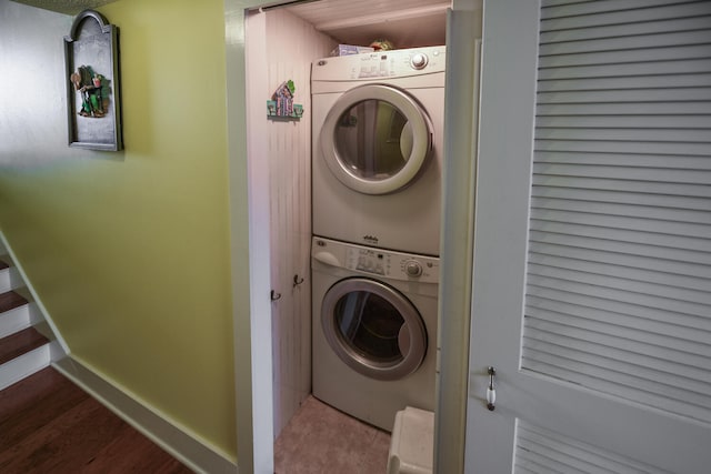 laundry area with tile patterned floors and stacked washer / dryer