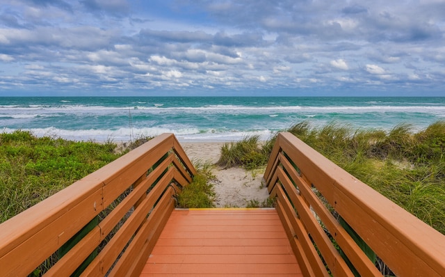 exterior space featuring a water view and a view of the beach