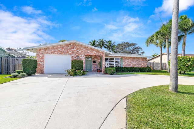 single story home featuring a garage and a front lawn