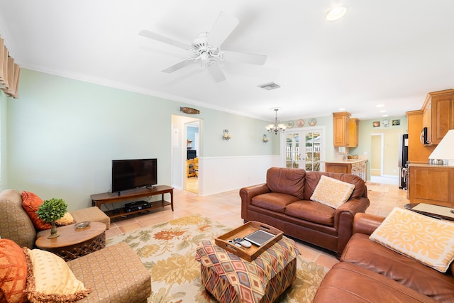 living room with light tile patterned floors, french doors, ceiling fan with notable chandelier, and crown molding