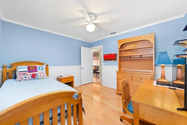 bedroom with ceiling fan, crown molding, and wood-type flooring