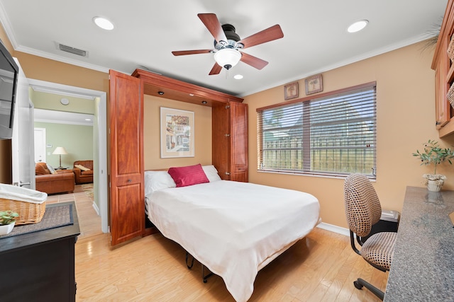 bedroom with light wood-type flooring, ceiling fan, and crown molding