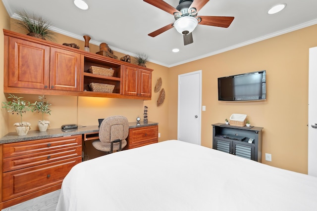 bedroom featuring built in desk, ceiling fan, and crown molding