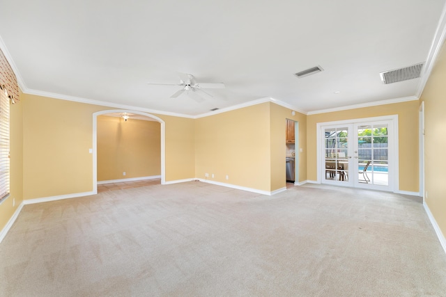 unfurnished living room with light carpet, french doors, ornamental molding, and ceiling fan