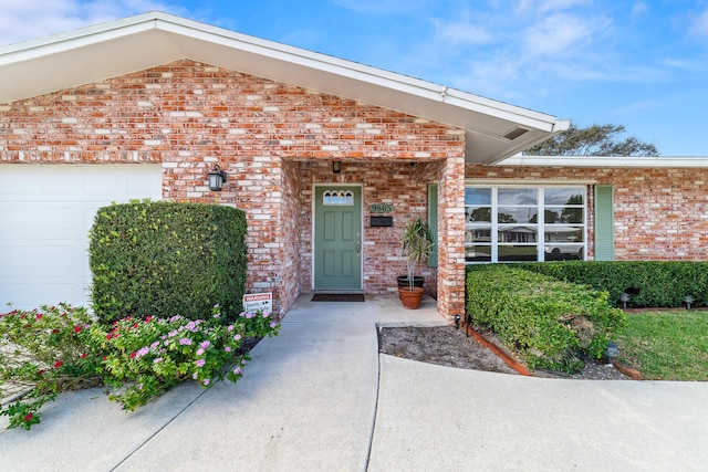 view of exterior entry with a garage