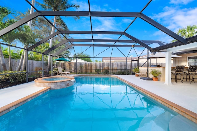 view of swimming pool featuring a lanai, a patio, an in ground hot tub, and an outdoor bar