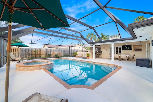 view of swimming pool featuring a bar, an in ground hot tub, a patio area, ceiling fan, and a lanai