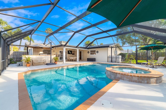 view of pool with an in ground hot tub, a lanai, and a patio area