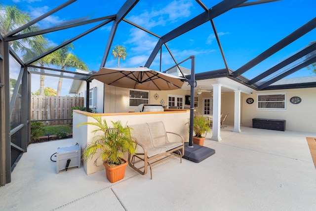 view of patio / terrace featuring ceiling fan and a lanai