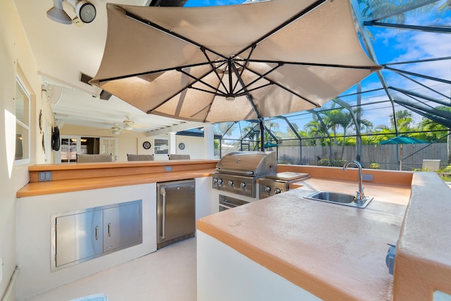 view of patio / terrace featuring exterior kitchen, sink, a lanai, and area for grilling