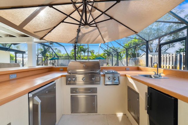 view of patio with a lanai, a grill, an outdoor kitchen, and sink