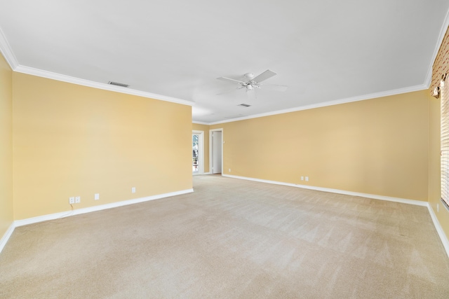 carpeted spare room with ceiling fan and crown molding