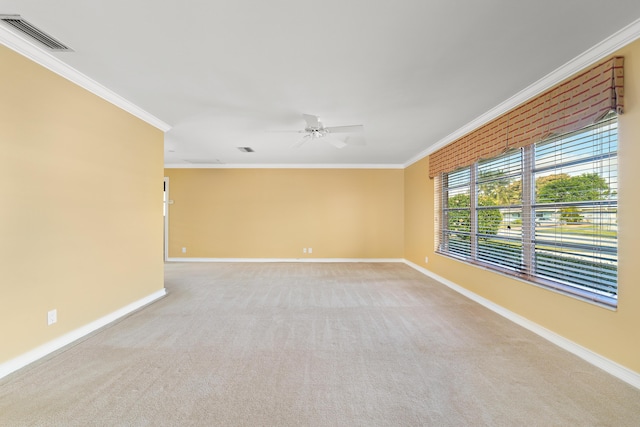 empty room featuring light carpet, ceiling fan, and ornamental molding