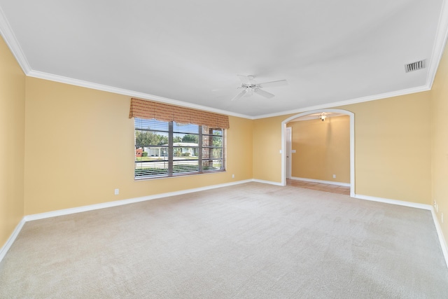 carpeted empty room featuring ceiling fan and crown molding