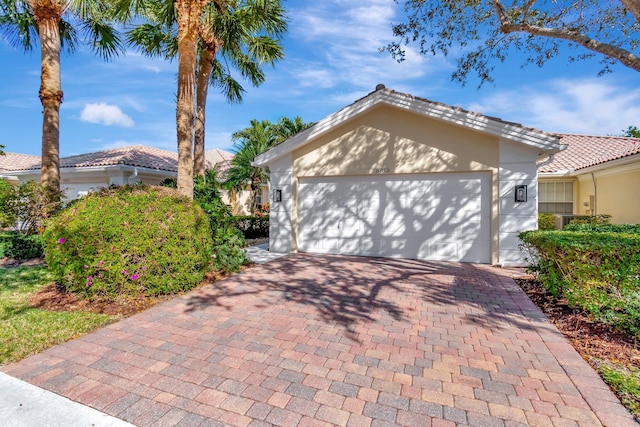 view of front of house featuring a tiled roof and decorative driveway