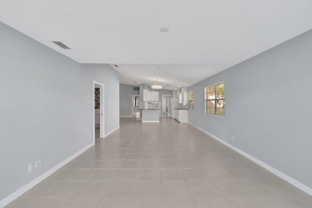 hall featuring light tile patterned floors