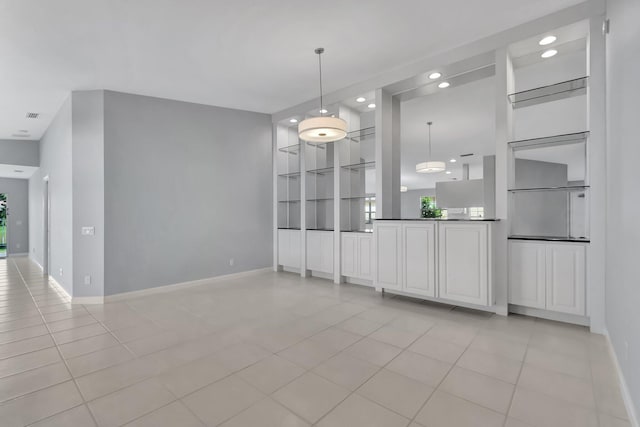 interior space featuring built in shelves and light tile patterned floors