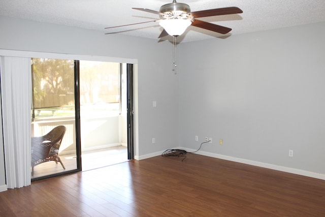 spare room with ceiling fan, wood-type flooring, and a textured ceiling