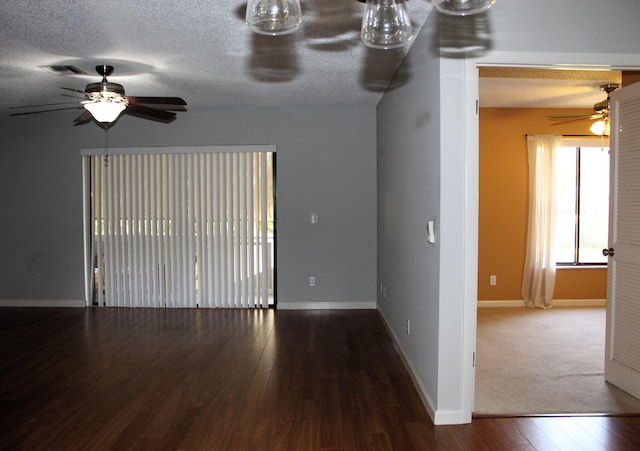 empty room with hardwood / wood-style flooring, ceiling fan, and a textured ceiling