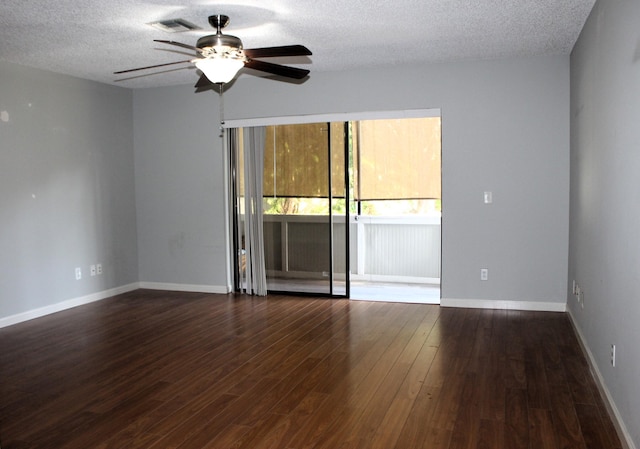 unfurnished room featuring ceiling fan, dark wood-type flooring, and a textured ceiling