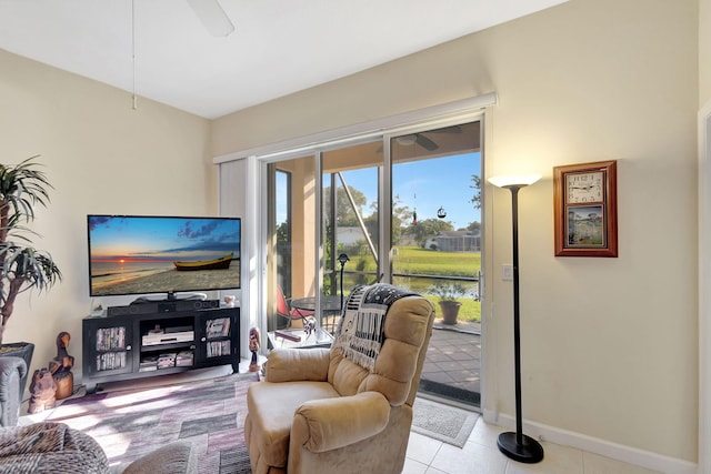 sitting room with ceiling fan and light tile patterned flooring