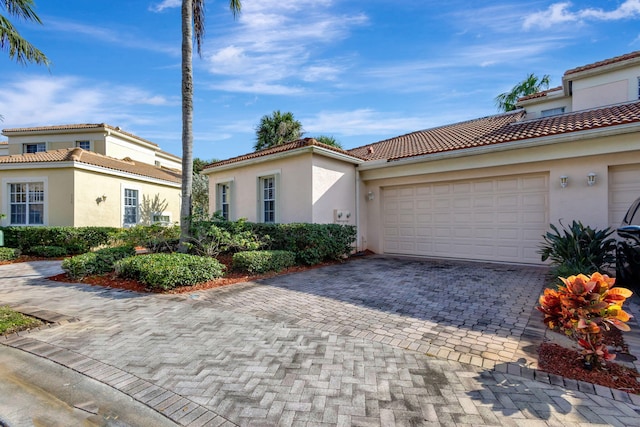 mediterranean / spanish-style house featuring a garage