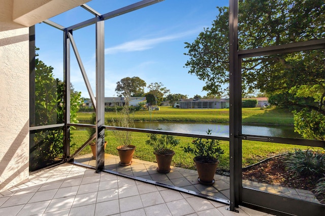 unfurnished sunroom with a wealth of natural light and a water view