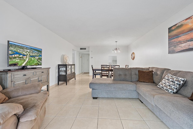 living room with light tile patterned floors and a notable chandelier