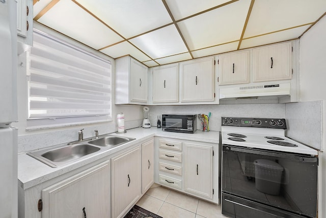 kitchen featuring white cabinetry, electric range, sink, and light tile patterned floors