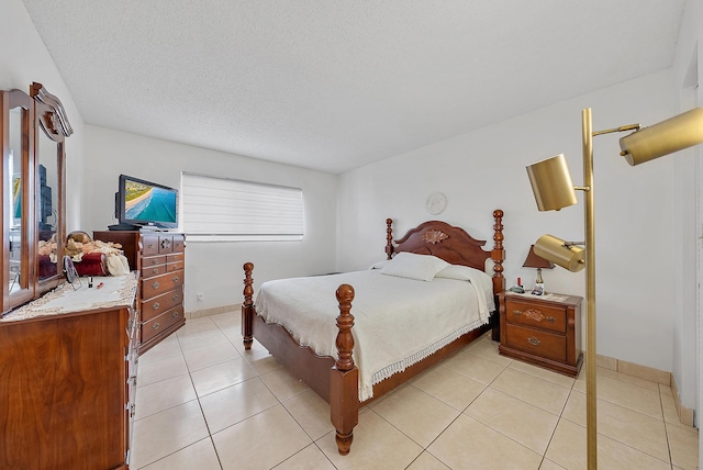 tiled bedroom featuring a textured ceiling