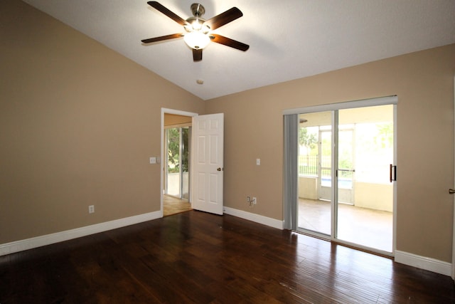 empty room featuring dark wood-style floors, vaulted ceiling, baseboards, and ceiling fan