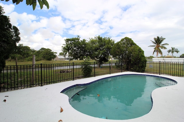 view of swimming pool with a fenced in pool, a yard, and fence