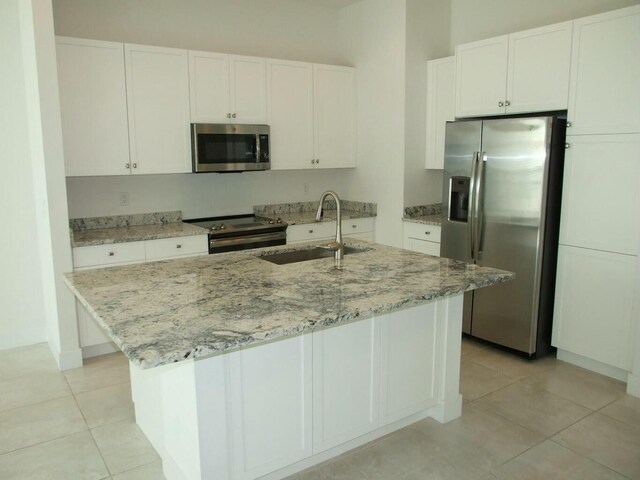 kitchen featuring white cabinetry, sink, an island with sink, and appliances with stainless steel finishes