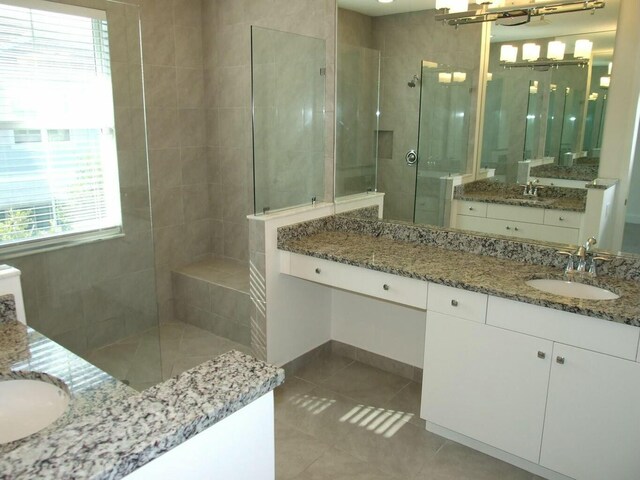 bathroom featuring tile patterned floors, vanity, and an enclosed shower