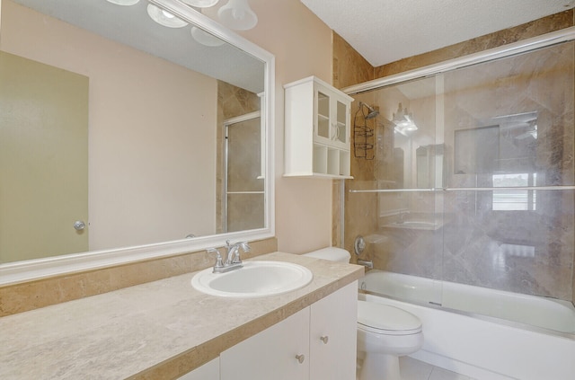 full bathroom featuring bath / shower combo with glass door, a textured ceiling, vanity, tile patterned flooring, and toilet