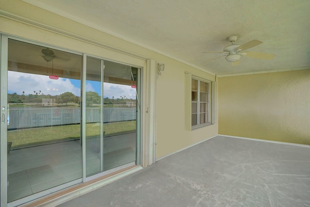 unfurnished sunroom with ceiling fan