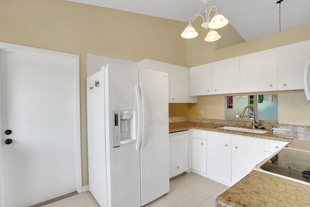 kitchen featuring white appliances, sink, pendant lighting, white cabinets, and a chandelier