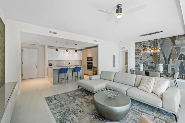 living room with electric panel and ceiling fan