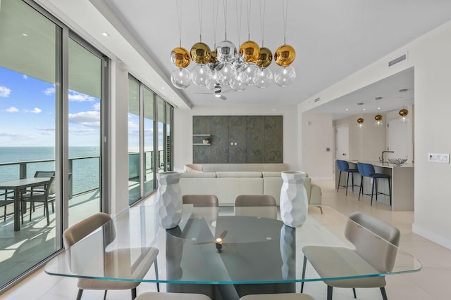 tiled dining room featuring a water view